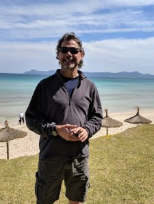 BJ, a coach with Velocious Cycling Adventures, on the beach of Majorca Spain, ready to work a two week cycling adventure.
